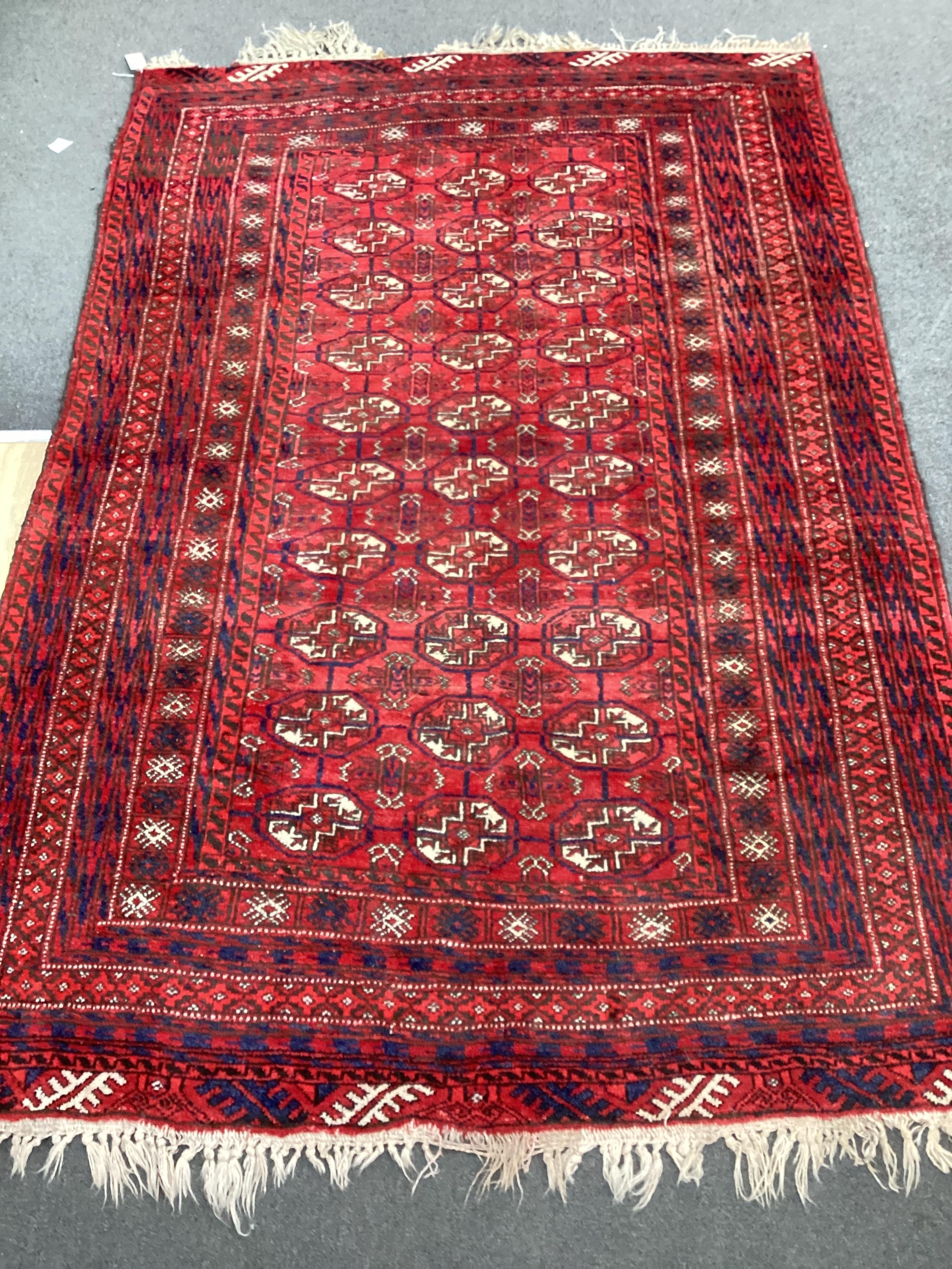 A Bokhara red ground rug, 210cm x 146cm